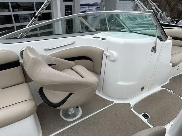 Slide: The Image of 2015 Hurricane SD 2400 I/O boat interior with beige seating and steering area. - 29