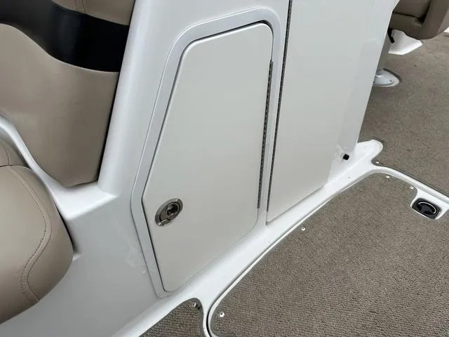 Slide: The Image of 2015 Hurricane SD 2400 I/O boat interior storage compartment with beige seating and carpeted floor. - 30