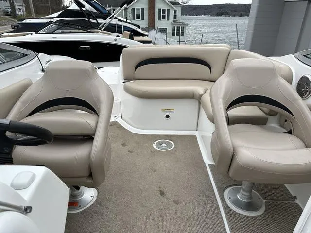 Slide: The Image of 2015 Hurricane SD 2400 I/O boat interior with beige seating and lake view. - 32