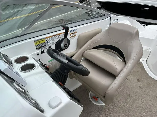 Slide: The Image of 2015 Hurricane SD 2400 I/O boat cockpit with steering wheel and beige captain's chair. - 34