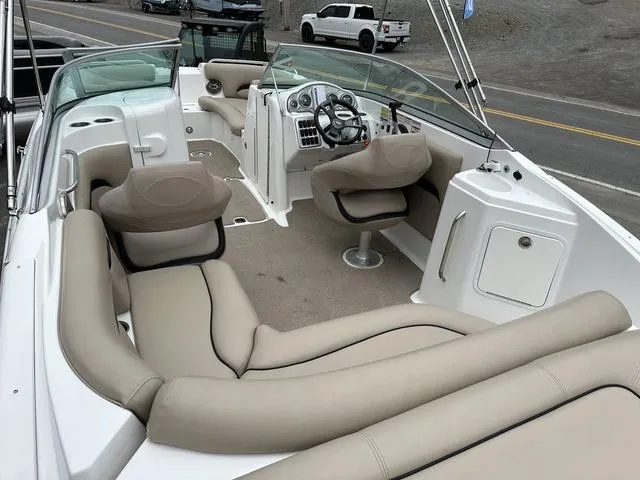 Slide: The Image of 2015 Hurricane SD 2400 I/O boat interior with beige seating and steering console. - 37
