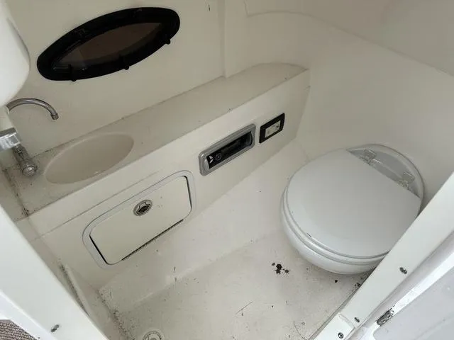Slide: The Image of 2015 Hurricane SD 2400 I/O boat bathroom with toilet and sink. - 39
