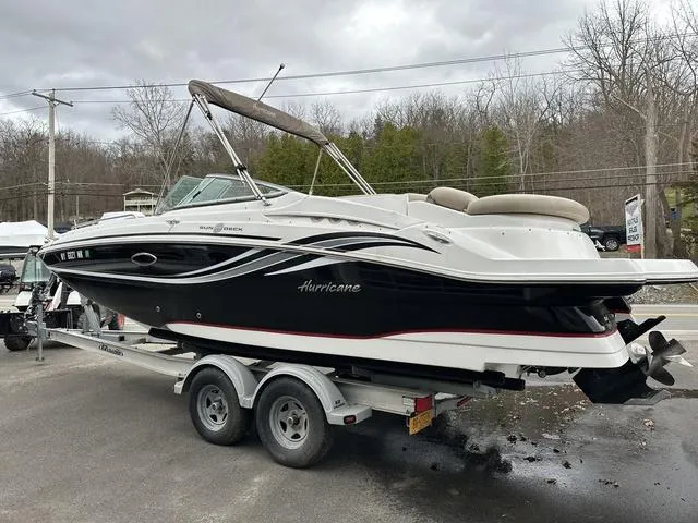 Slide: The Image of 2015 Hurricane SD 2400 I/O boat on trailer, black and white design, parked outdoors. - 5