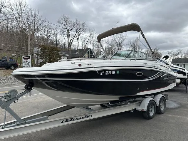 Slide: The Image of 2015 Hurricane SD 2400 I/O boat on trailer, parked outdoors under cloudy sky. - 6