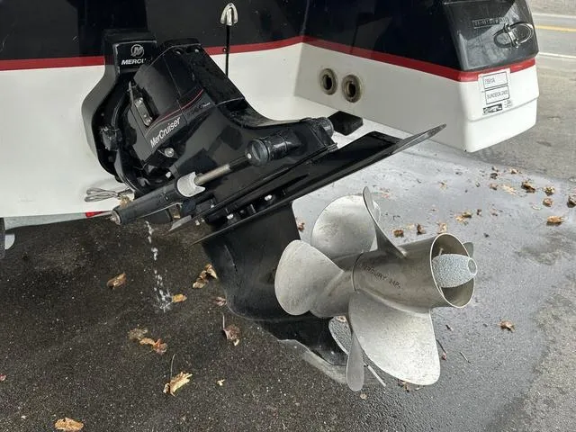 Slide: The Image of 2015 Hurricane SD 2400 I/O boat with MerCruiser outdrive and propeller, parked on wet pavement. - 8