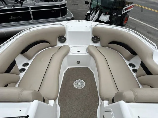 Slide: The Image of 2015 Hurricane SD 2400 I/O boat interior with beige seating and carpeted floor. - 9