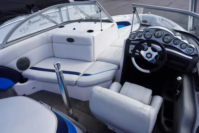 Slide: The Image of 2004 Supra COMP LTS/SK boat interior with white seating and modern dashboard. - 12