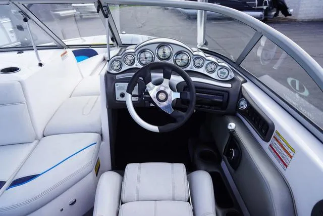 Slide: The Image of 2004 Supra COMP LTS/SK boat interior with steering wheel and dashboard gauges. - 13