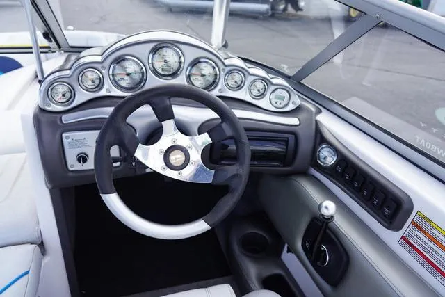 Slide: The Image of 2004 Supra COMP LTS/SK boat dashboard with gauges and steering wheel. - 14