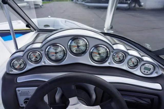 Slide: The Image of Dashboard of a 2004 Supra COMP LTS/SK boat with multiple gauges and steering wheel. - 15