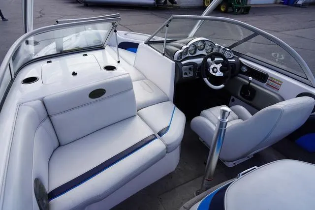 Slide: The Image of 2004 Supra COMP LTS/SK boat interior with white seating and modern dashboard. - 16