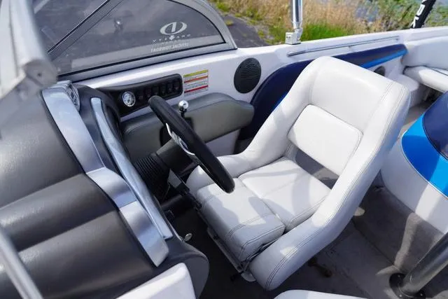 Slide: The Image of 2004 Supra COMP LTS/SK boat interior with white seating and steering wheel. - 18