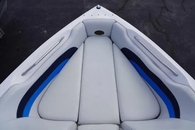 Slide: The Image of 2004 Supra COMP LTS/SK boat interior with white and blue cushioned seating. - 19