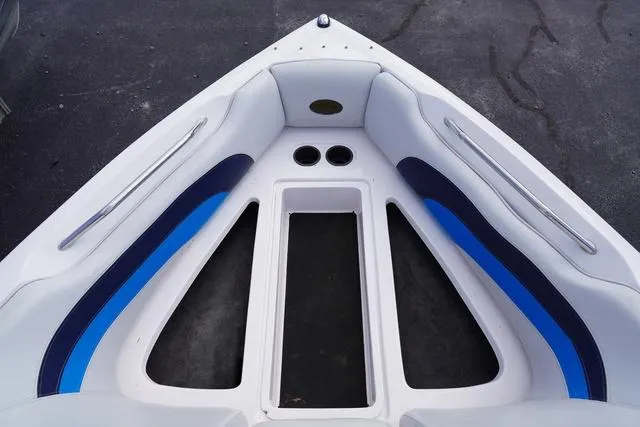 Slide: The Image of Bow seating area of a 2004 Supra COMP LTS/SK boat with blue and white upholstery. - 21