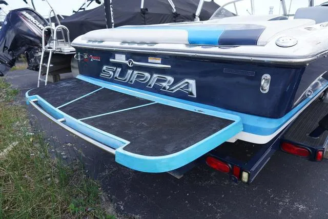 Slide: The Image of 2004 Supra COMP LTS/SK boat with blue and black detailing, rear view. - 4