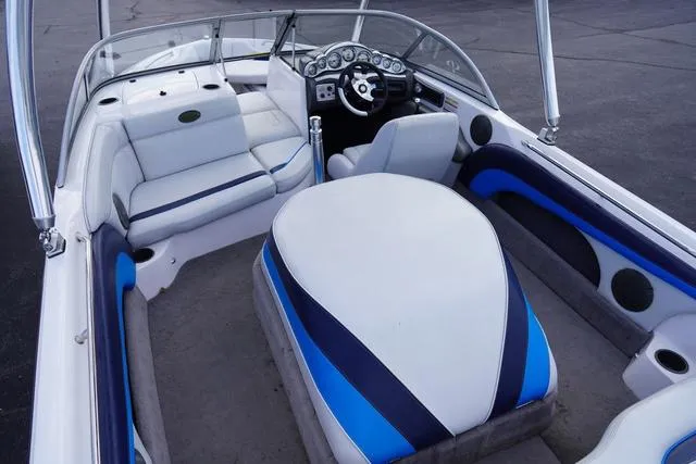 Slide: The Image of 2004 Supra COMP LTS/SK boat interior with white and blue seating and dashboard. - 7