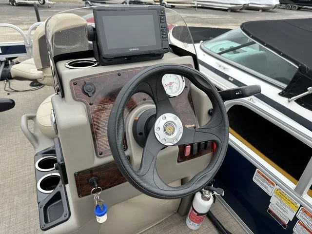 Slide: The Image of 2023 Sun Tracker Bass Buggy® 16 XL Select dashboard with steering wheel and Garmin display. - 15