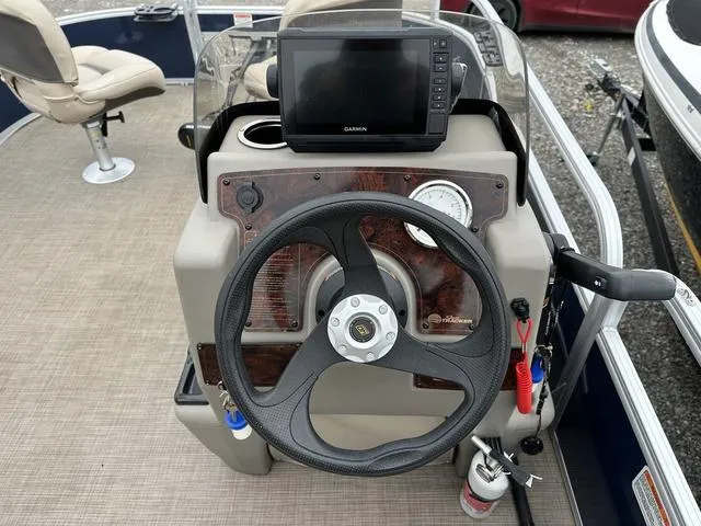 Slide: The Image of 2023 Sun Tracker Bass Buggy® 16 XL Select steering console with Garmin display and controls. - 18