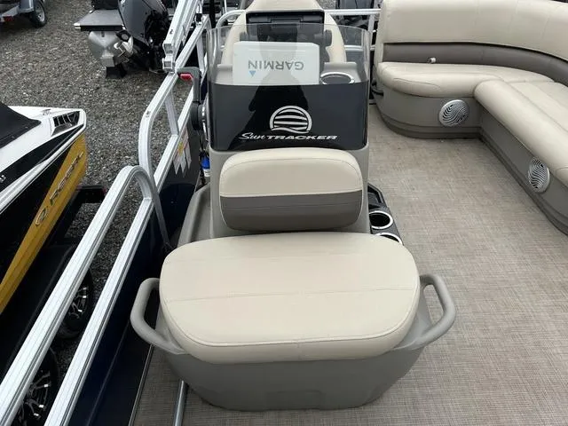 Slide: The Image of 2023 Sun Tracker Bass Buggy® 16 XL Select interior with beige seating and Garmin equipment. - 23