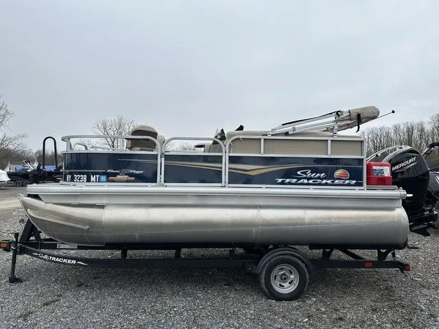 Slide: The Image of 2023 Sun Tracker Bass Buggy® 16 XL Select pontoon boat on trailer, side view. - 8