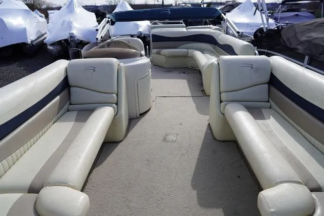 Slide: The Image of 2008 Bennington 2250 pontoon boat interior with spacious seating and neutral upholstery. - 13