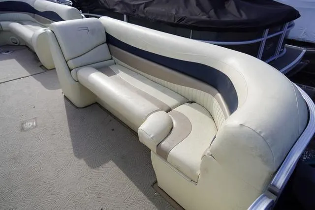 Slide: The Image of 2008 Bennington 2250 boat interior with beige and gray seating. - 15
