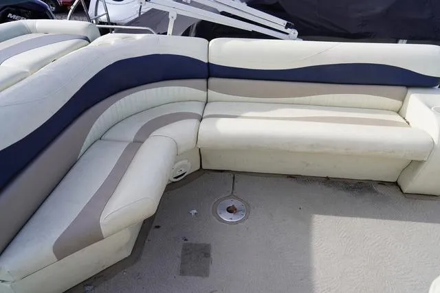 Slide: The Image of 2008 Bennington 2250 boat interior with beige and blue seating arrangement. - 16