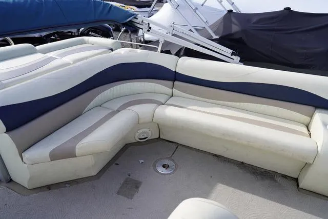 Slide: The Image of 2008 Bennington 2250 boat interior with beige and blue seating arrangement. - 17