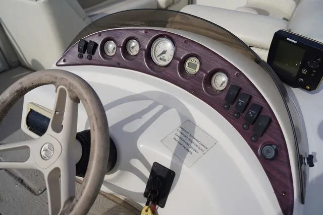 Slide: The Image of Steering console of a 2008 Bennington 2250 boat with gauges and controls. - 18