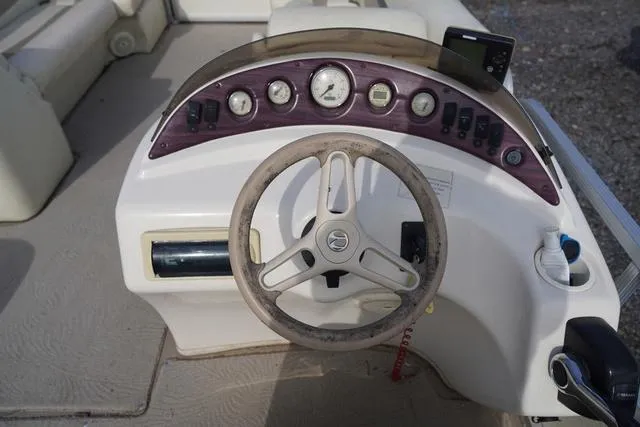 Slide: The Image of Steering console of a 2008 Bennington 2250 boat with gauges and controls. - 19