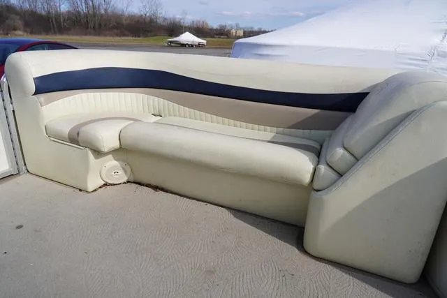 Slide: The Image of 2008 Bennington 2250 boat seating, cream and navy upholstery, outdoor setting. - 22