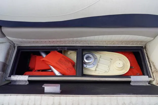 Slide: The Image of Storage compartment in a 2008 Bennington 2250 boat with life jackets and equipment. - 5