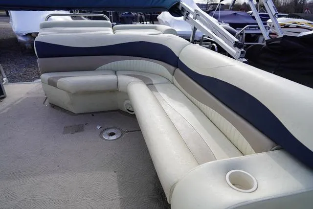 Slide: The Image of 2008 Bennington 2250 boat interior with beige and blue seating. - 9