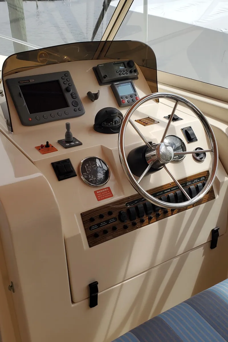 Slide: The Image of 2006 Mainship 34 Rum Runner Classic helm with steering wheel and navigation instruments. - 11
