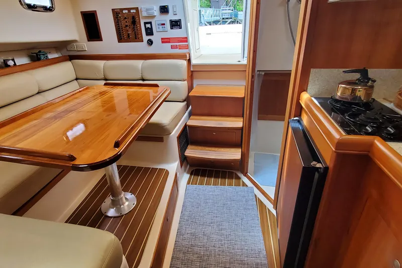 Slide: The Image of Interior of 2006 Mainship 34 Rum Runner Classic with dining area and kitchen. - 26