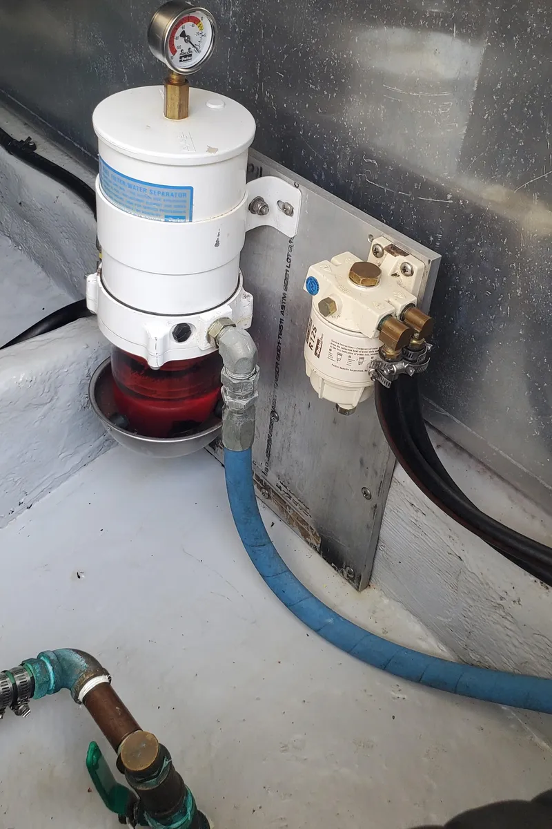 Slide: The Image of Fuel filter system in 2006 Mainship 34 Rum Runner classic boat engine compartment. - 33