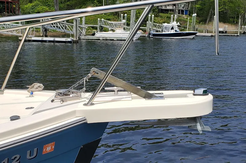 Slide: The Image of 2006 Mainship 34 Rum Runner Classic boat docked on calm water. - 6