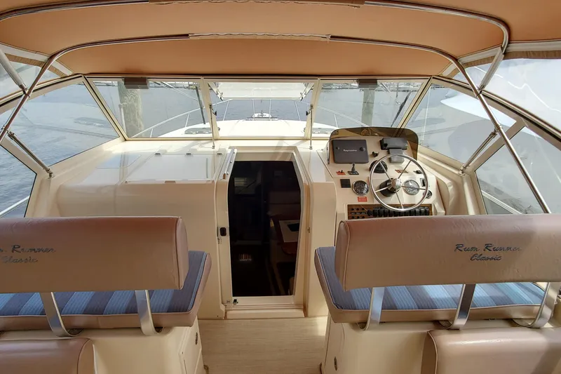 Slide: The Image of 2006 Mainship 34 Rum Runner Classic boat interior with helm and seating. - 9