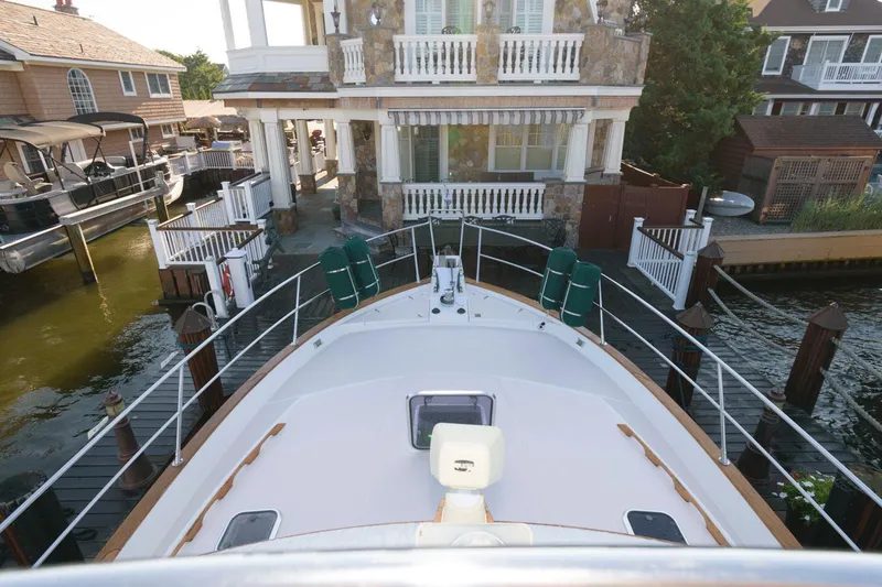 Slide: The Image of Sabreline 47 Motor Yacht, 2000 model, docked near waterfront homes. - 11