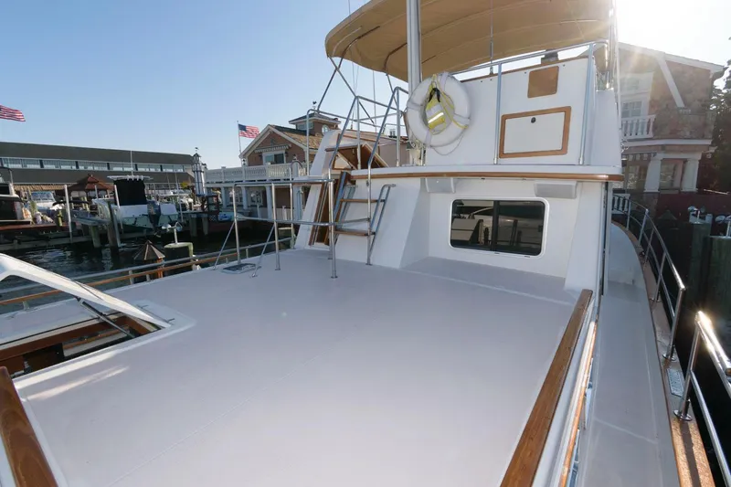 Slide: The Image of 2000 Sabreline 47 Motor Yacht deck with ladder and dock view. - 15