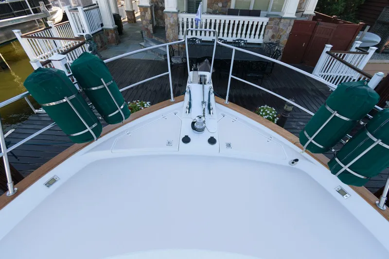 Slide: The Image of Bow view of 2000 Sabreline 47 Motor Yacht docked with green fenders. - 17