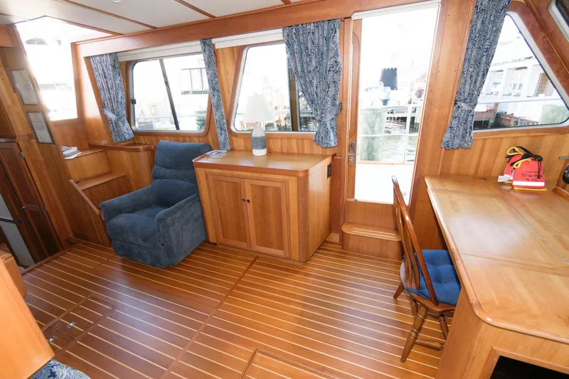 Slide: The Image of Interior of 2000 Sabreline 47 Motor Yacht with wooden flooring and blue furnishings. - 23