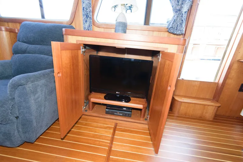 Slide: The Image of Interior of 2000 Sabreline 47 Motor Yacht with TV cabinet and recliner. - 24