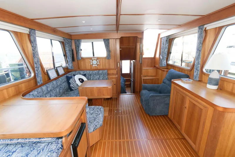 Slide: The Image of Interior of 2000 Sabreline 47 Motor Yacht with wood finish and blue upholstery. - 25