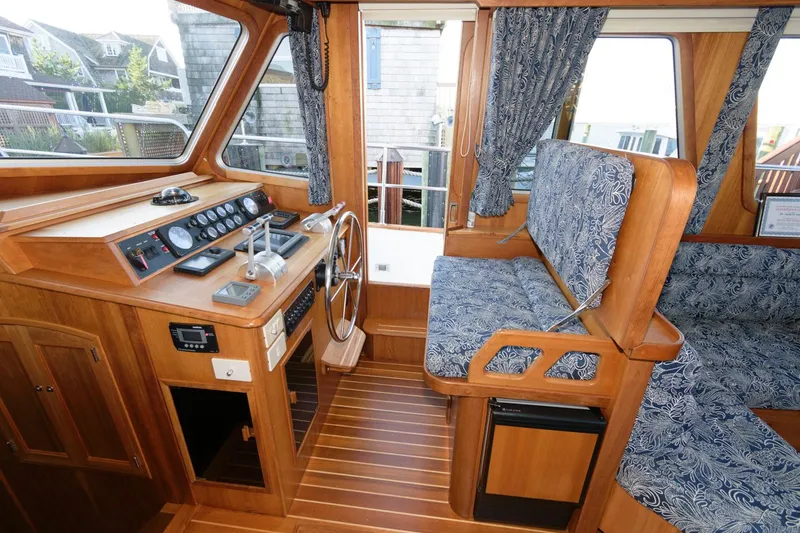 Slide: The Image of Interior of 2000 Sabreline 47 Motor Yacht with wooden helm and patterned seating. - 26