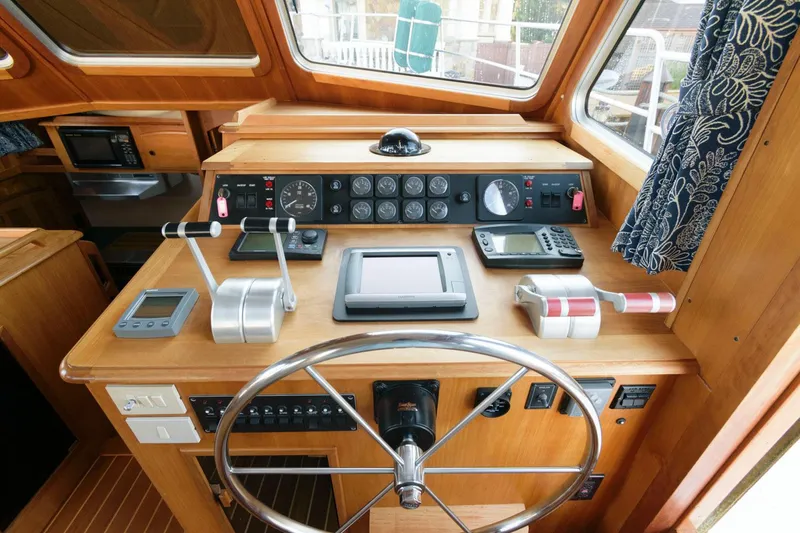 Slide: The Image of Cockpit of 2000 Sabreline 47 Motor Yacht with navigation controls and steering wheel. - 28