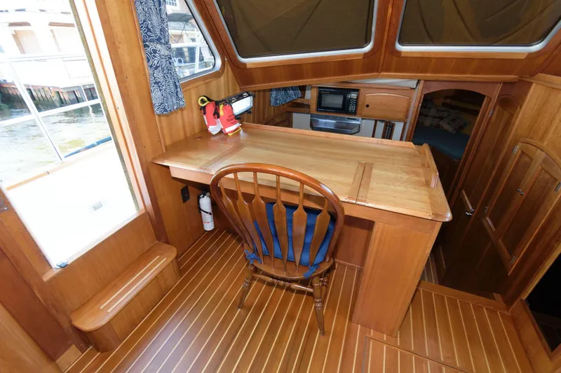 Slide: The Image of Interior of 2000 Sabreline 47 Motor Yacht with wooden desk and chair. - 29