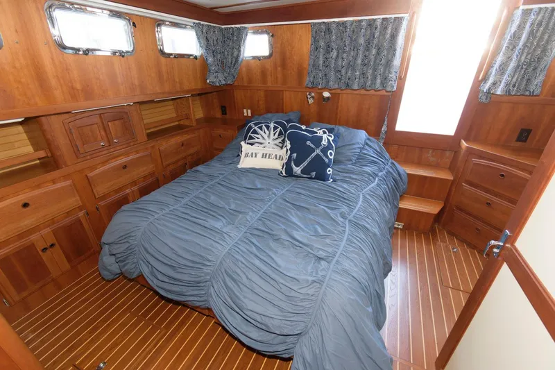 Slide: The Image of Cozy bedroom in 2000 Sabreline 47 Motor Yacht with wood paneling and nautical decor. - 32