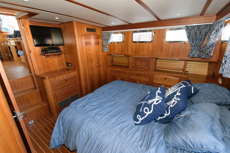 Slide: The Image of Sabreline 47 Motor Yacht 2000 interior with cozy bedroom, wooden finish, and nautical decor. - 33
