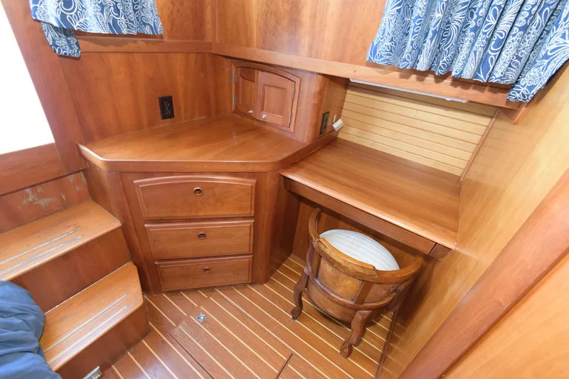 Slide: The Image of Interior of 2000 Sabreline 47 Motor Yacht with wooden desk and drawers. - 34